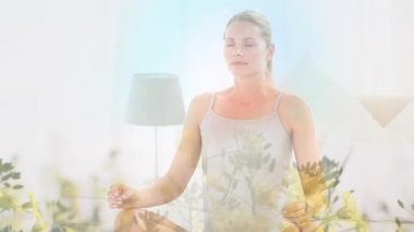Beyaz kadın üzerinde yoga ve meditasyon yapan çiçeklerin animasyonu. dünya meditasyon günü ve dijital olarak üretilen video konsepti.
