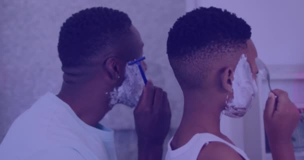 非洲裔美国人的父亲和儿子刮胡子背后的灯光动画 花质量时间概念数字化生成的视频 — 图库视频影像