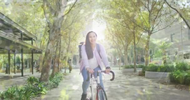 Animación Hojas Sobre Sonriente Asiática Mujer Ciclismo Bicicleta Nacional Día — Vídeos de Stock