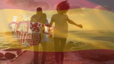 Sahildeki Afro-Amerikan çifti üzerinden İspanya bayrağı animasyonu. Vatanseverlik ve kutlama konsepti dijital olarak oluşturulmuş video.