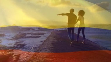 Sahildeki Afro-Amerikan çifti yerine Kolombiya bayrağının canlandırılması. Vatanseverlik ve kutlama konsepti dijital olarak oluşturulmuş video.