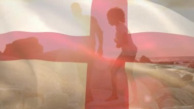 Sahildeki Afro-Amerikan çifti yerine İngiliz bayrağının canlandırılması. Vatanseverlik ve kutlama konsepti dijital olarak oluşturulmuş video.