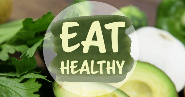 Image of eat healthy text over kiwi fruit. national vegetarian week and celebration concept digitally generated image.