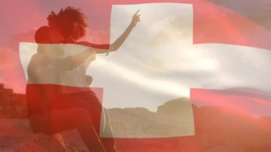 Sahildeki Afrikalı Amerikalı çift yerine İsviçre bayrağı animasyonu. Vatanseverlik ve kutlama konsepti dijital olarak oluşturulmuş video.