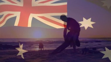 Avustralya bayrağının sahilde köpekli beyaz bir adam üzerinde canlandırılması. Vatanseverlik ve kutlama konsepti dijital olarak oluşturulmuş video.