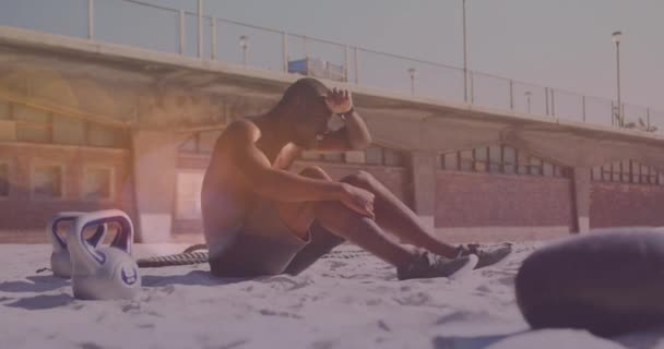 Světelné Skvrny Proti Unavenému Afroameričanovi Který Dává Pauzu Cvičení Pláži — Stock video