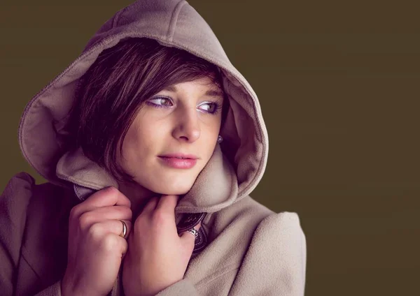 Caucasian woman wearing a hoodie against copy space on brown background. beauty and skin care concept