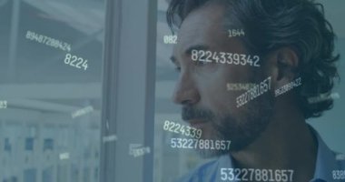 Animation of numbers over caucasian businessman smiling. global business, finances, connections and digital interface concept digitally generated video.