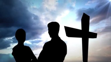 Bulut ve haç üzerindeki çiftlerin siluetinin animasyonu. din ve inanç kavramı dijital olarak oluşturulan video.