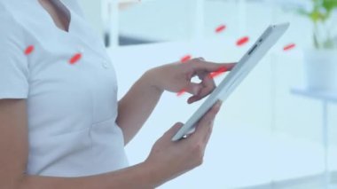 Tablet kullanan beyaz kadın doktor üzerinde kırmızı desenli animasyon. tıp, teknoloji ve veri işleme kavramı dijital olarak oluşturulmuş video.
