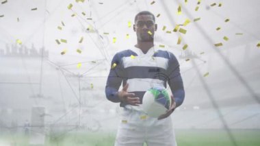 Afrika kökenli Amerikan ragbi oyuncusu üzerinde bulut ve konfeti animasyonu. global spor ve dijital arayüz konsepti dijital olarak oluşturulmuş video.