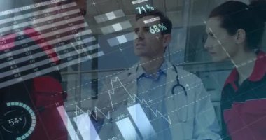 Animation of financial data over caucasian male doctor and paramedics talking. finance, economy, medicine, health and technology concept digitally generated video.