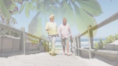 Ağaçtaki yeşil yapraklar, köprüde el ele tutuşan Kafkasyalı yaşlı çifte karşı. Ulusal Yürüyüş Günü Farkındalığı