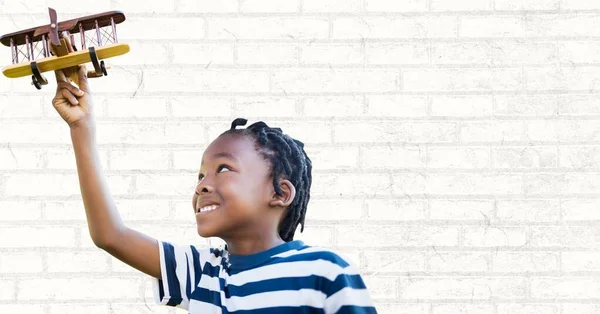 African American Boy Playing Toy Plane Copy Space Grey Brick — стоковое фото