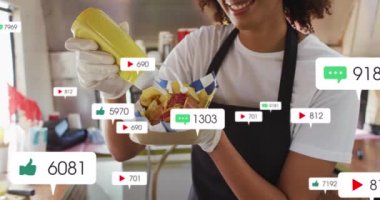 Afro-Amerikan bir kadının sosisli hazırlaması üzerine medya simgelerinin canlandırılması. Sosyal medya ve iletişim arayüzü kavramı dijital olarak oluşturulmuş video.