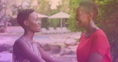 Two african american sisters hugging each other at a resort. national siblings day awareness concept