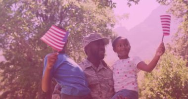 African american father in soldier uniform carrying his son and daughter in the garden. family, love and togetherness concept
