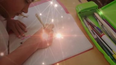 Glowing network of connections against mid section of caucasian girl drawing in her book at school. back to school and education concept
