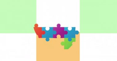 Hareket eden karelerle arka planda renkli bulmacalardan yapılmış kalp animasyonu. Ulusal bulmaca günü ve düşünme konsepti dijital olarak oluşturulmuş video.