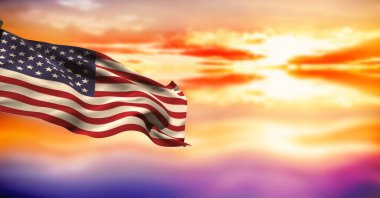 Composite image of waving american flag against sunset sky in background. national tourism and travel concept