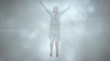 Animation of light spots over biracial businesswoman jumping with arms outstretched. never give up day and celebration concept digitally generated video.