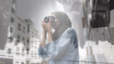 Animation of light over biracial female photographer taking pictures. photography, optics and hobby concept digitally generated video.