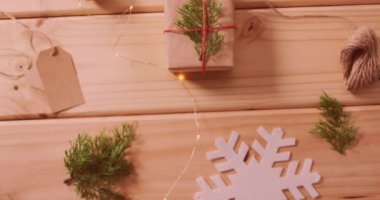 Animation of merry christmas text over christmas decorations. christmas, celebration and digital interface concept digitally generated video.
