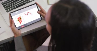 Ekranda Nft ile tablet üzerinde çalışan melez bir kadının videosu. iş, işbirliği, dijital kaynaklar ve dijital olarak üretilen teknoloji konseptiyle ofiste çalışmak.