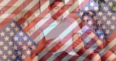 Animation of american flag over caucasian father and children with gifts. national sons and daughters day and celebration concept digitally generated video.
