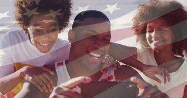 Animation of american flag over african american father and children taking selfie. national sons and daughters day and celebration concept digitally generated video.