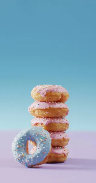 ピンクと青の背景にピンクと青の霜でドーナツのスタックの垂直画像 甘いものと飴 — ストック写真