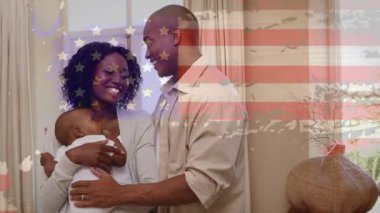 Animation of flag of usa waving over happy african american parents with baby. family, parenthood, togetherness and patriotism concept digitally generated video.