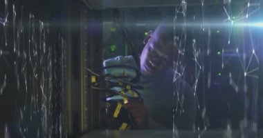 Animation of connections over african american man working in server room. network, programming, computers and technology concept digitally generated video.