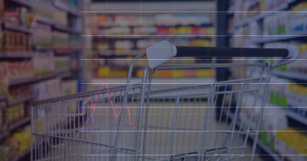 Image of data processing over trolley in shop. global business, shopping and digital interface concept digitally generated image.