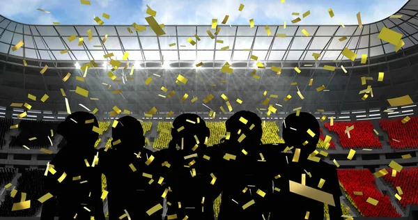 スポーツスタジアムを応援するファンのシルエットに落ちる黄金のコンフェッティ スポーツ競技とトーナメントのコンセプト — ストック写真