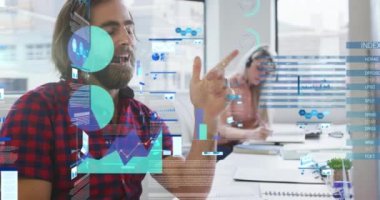 Statistical data processing against caucasian man talking on a video call at office. business technology concept