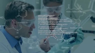 Animation of scientific data over caucasian male and female scientists in laboratory. global science, research and data processing concept digitally generated video.