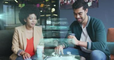 Screens with data processing against diverse male and female office colleagues discussing at office. business technology concept