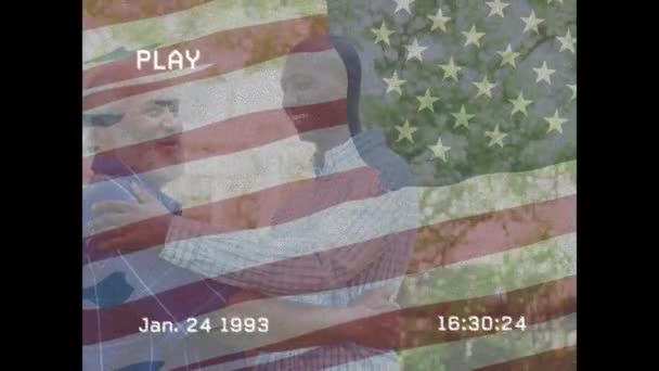 Animation Interference Flag Usa Diverse Man His Adult Son Global — Vídeo de stock
