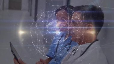 Animation of network of connections over diverse female and male doctors using tablet. medicine, health, connections and technology concept digitally generated video.