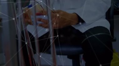 Animation of network of connections over biracial male doctor. medicine, health, connections and technology concept digitally generated video.