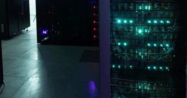 Image of empty corridor with rows of red and green lights in computer servers. global technology, data processing and connections concept.