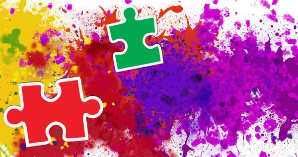 Image of colourful puzzle over colourful stains. creative month and celebration concept digitally generated image.