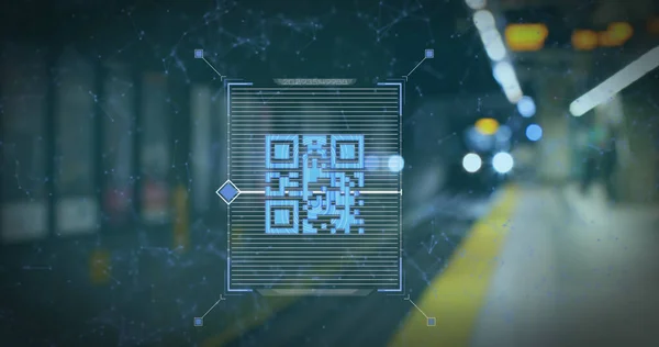 Image of a blue QR code scanning with a blue web of connections over an underground train going into the station. Digital composite image