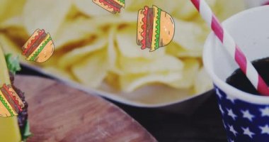 Hamburger simgelerinin ahşap yüzeydeki hamburgerlerin üzerinde canlandırılması. Dünya Gıda Günü konsepti dijital olarak üretilen video.