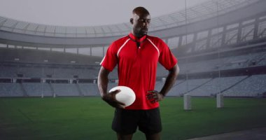 Animation of african american male rugby player with ball over stadium. global sport and rugby league world cup concept digitally generated video.