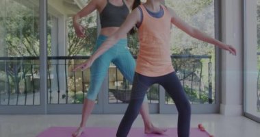 Animation of horoscope zodiac libra star sign over caucasian mum and daughter practicing yoga. Star signs, horoscope and yoga meditation concept digitally generated video.