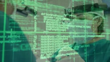 Animation of data processing over caucasian male and female surgeons talking. global medicine and digital interface concept digitally generated video.