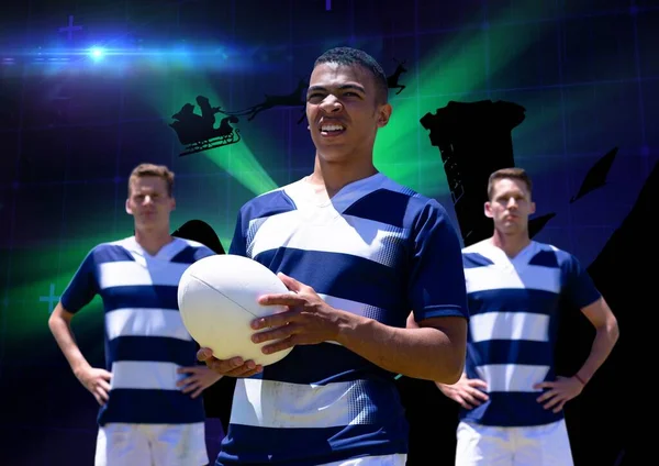 Team of diverse male rugby players against green spot of light on blue background. sports and technology concept
