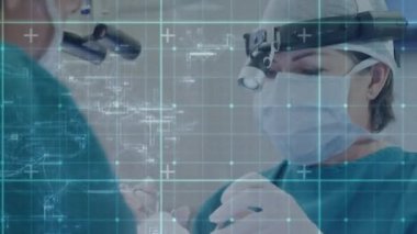 Animation of data processing over caucasian male and female surgeons talking. global medicine and digital interface concept digitally generated video.